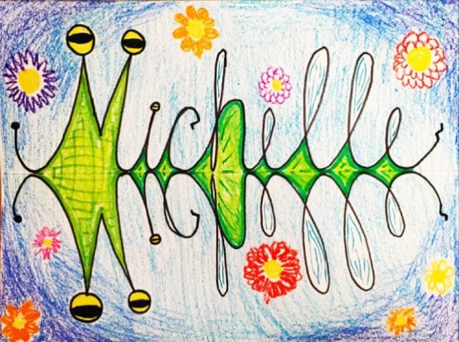 The name Michelle written in cursive with a reflected version below, colored to look like a bug (Third Grade Art Projects)