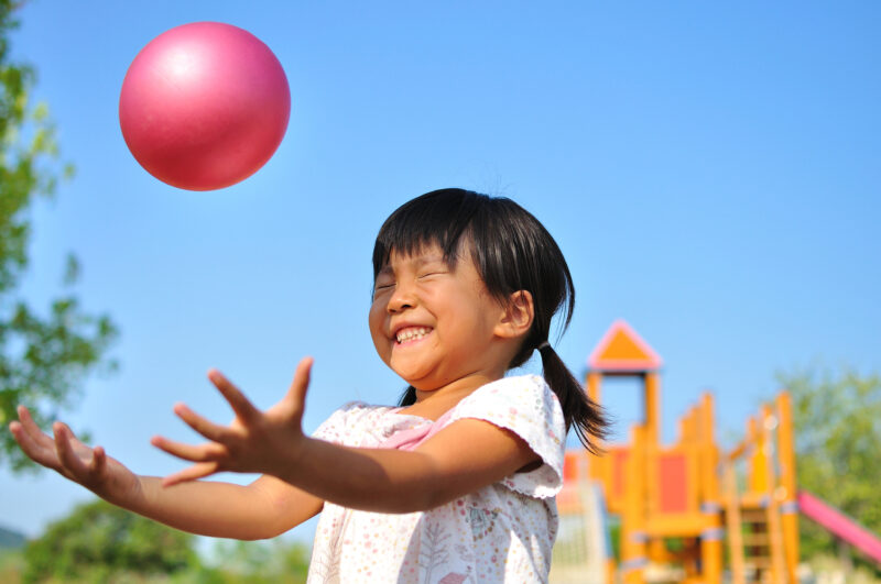 Girl's playing with ball, s an example of gross motor activities.