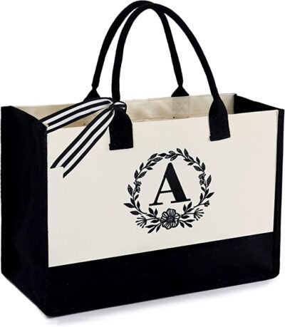 A black and canvas tote bag has a letter A embroidered on it.