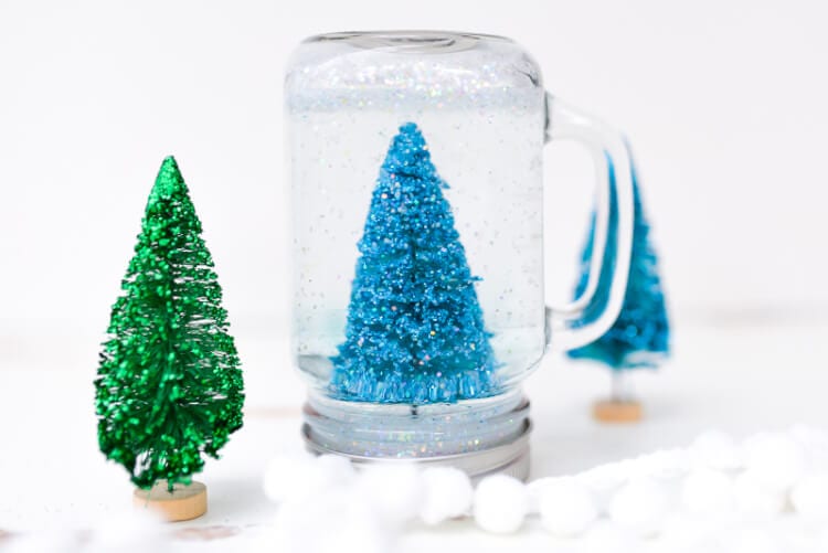 Glittery trees in a mason jar as a snow globe.