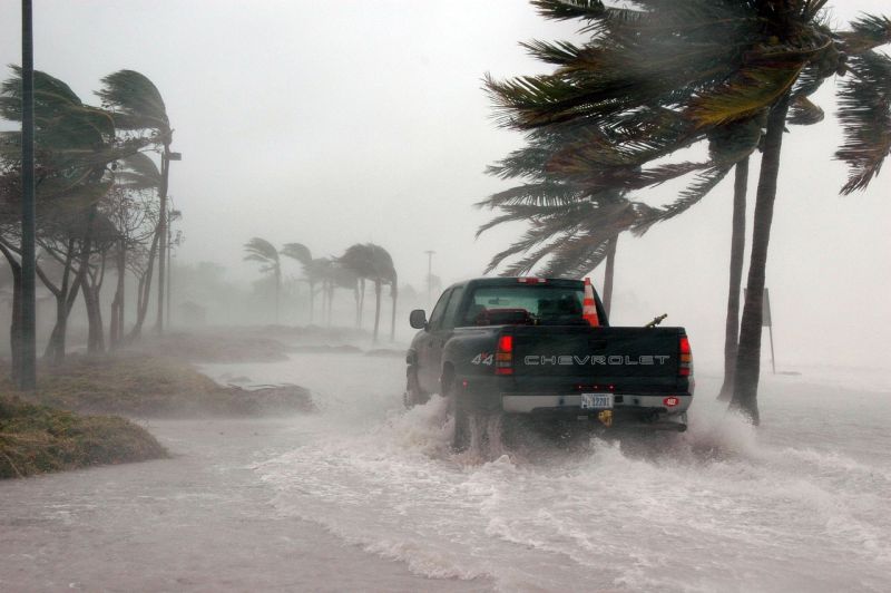 Pickup truck driving through flooded streets in a storm