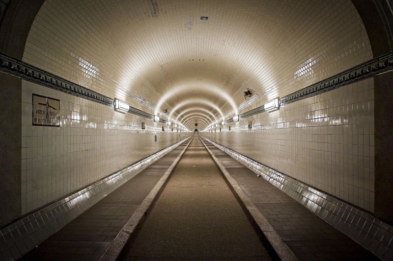 A white-tiled tunnel stretching far into the distance