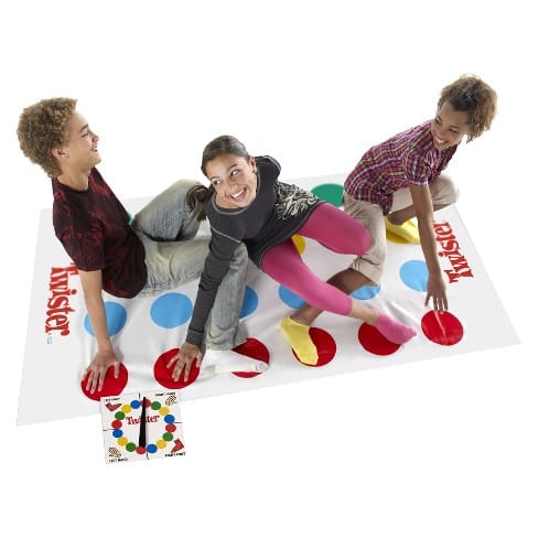 Three kids playing the game Twister as an example of indoor recess games and activities