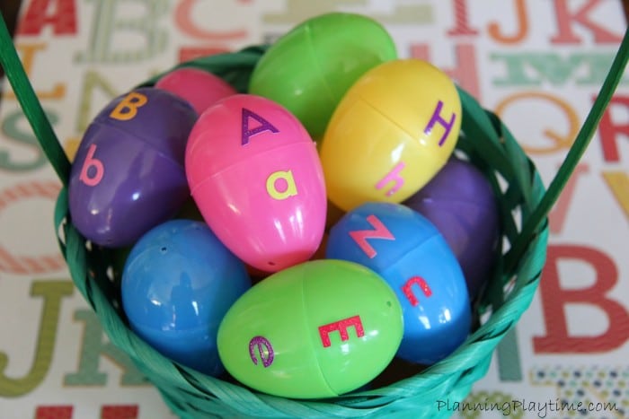 A basket of plastic eggs is shown. The upper case letter is on the top part of the egg and the lower on the bottom.