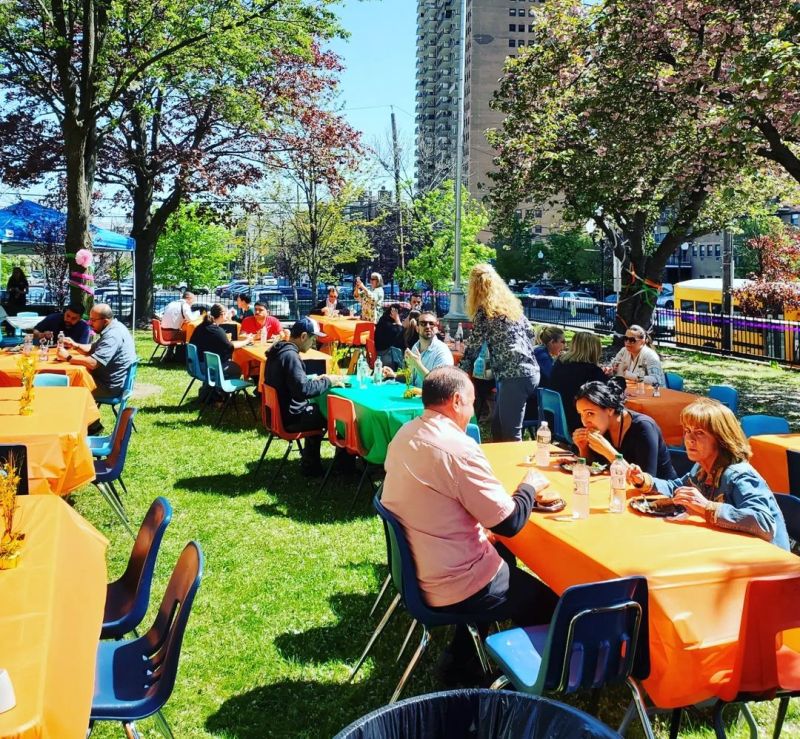 Teachers eating lunch outdoors at colorful tables for Teacher Appreciation Week