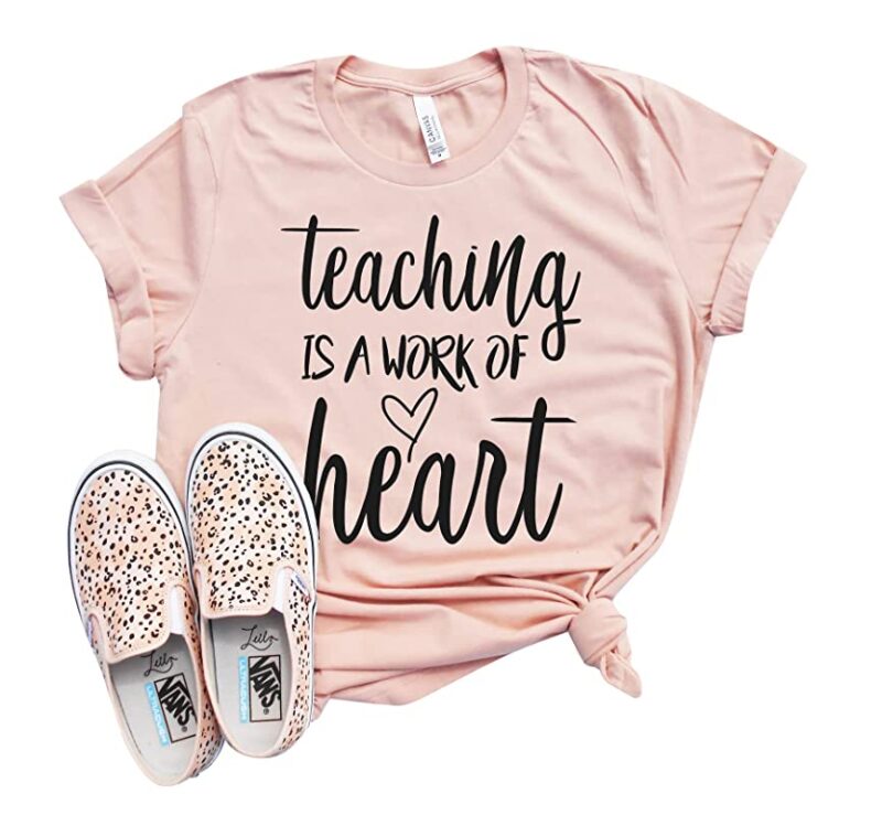 Pink Valentine's Day t-shirt that says Teaching Is a Work of Heart along with a pair of leopard print sneakers.