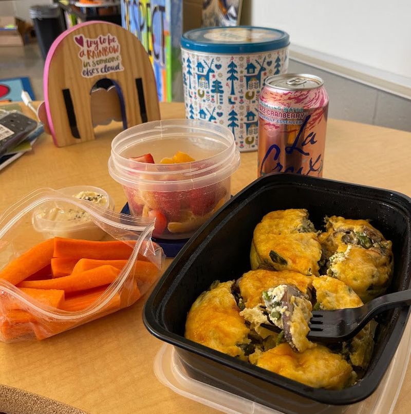 Teacher lunch consisting of veggie frittatas, bag of carrots, fruit, and La Croix can
