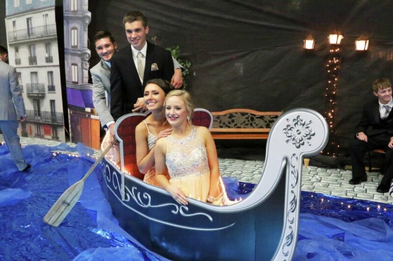 Students posing in a boat 