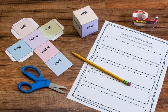 Paper cube with helping verbs on each side and a printable worksheet for writing sentences