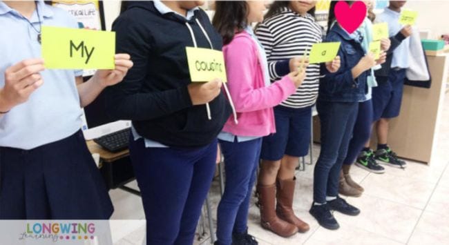 Kids lined up holding word cards to form a sentence