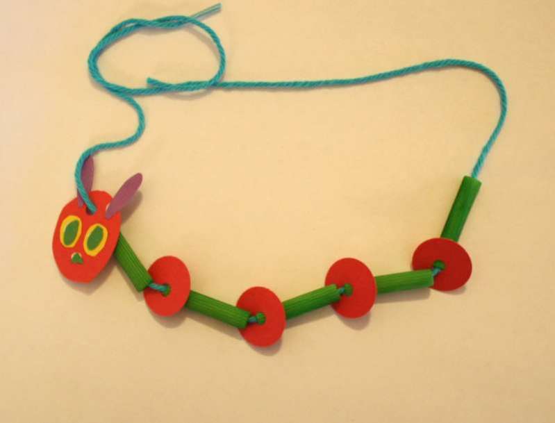 caterpillar necklace made from pasta noodles, paper discs and yarn (Very Hungry Caterpillar activities)