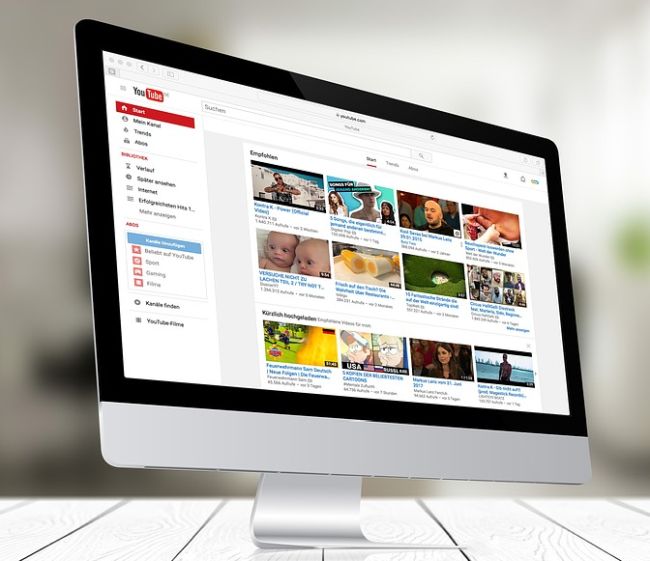 Computer monitor showing screen shot of YouTube (Virtual Rewards)