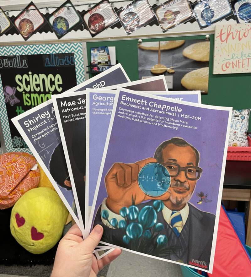 Black scientist posters being held up by a teachers in the classroom