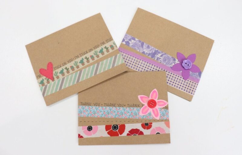 brown note cards have been decorated with decorative tape