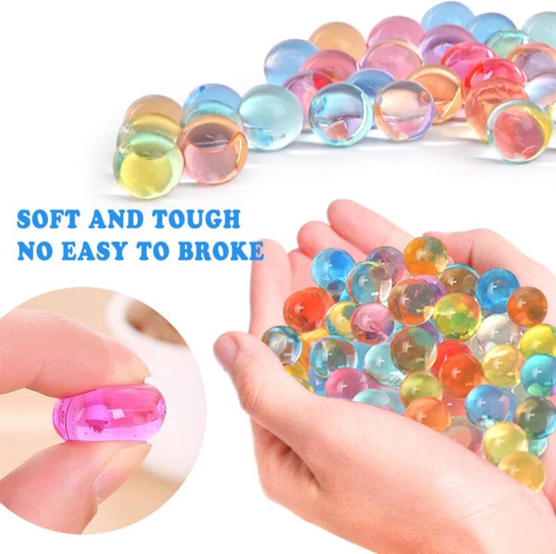 A hand is shown holding water beads which are small gel-like balls.
