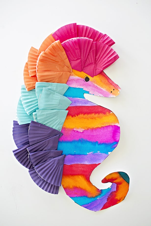 A colorfully striped sea horse art project as an example of summer crafts for kids