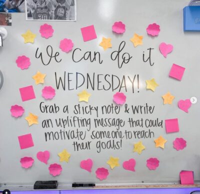 Sticky note white board with text 'We Can Do It Wednesday'