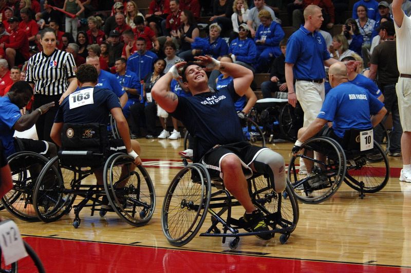 Men in wheelchairs playing basketball, as one laments a missed shot