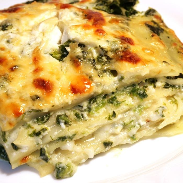 Vegetable lasagna piece served on a white plate, as one option for school cafeteria food picks
