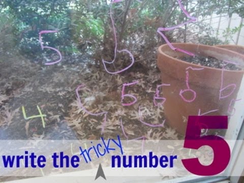The number 5 written on a window multiple times by a child.