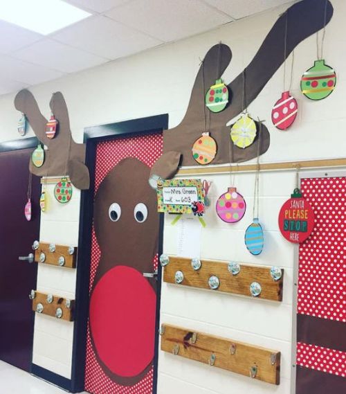 Winter classroom doors include this one decorated with a giant reindeer head, with ornaments hanging from the antlers 