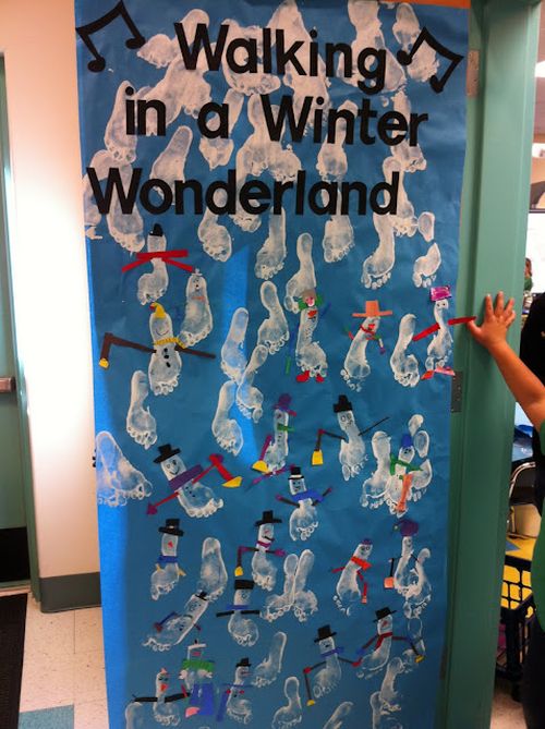 Classroom door decorated with white paint footprints reading Walking in a Winter Wonderland